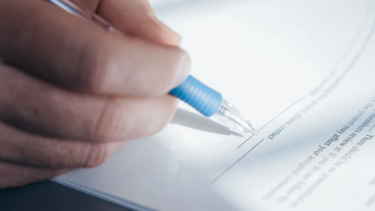 Close view of a formal document being signed