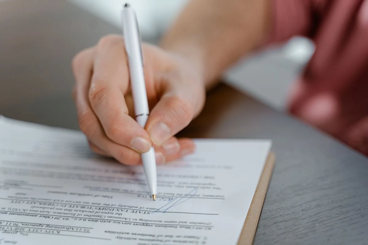 Hand completing a sworn statement